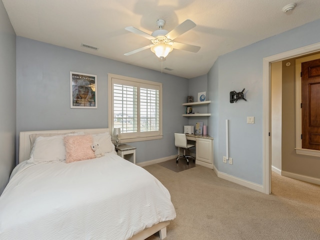 bedroom featuring baseboards, ceiling fan, visible vents, and light colored carpet