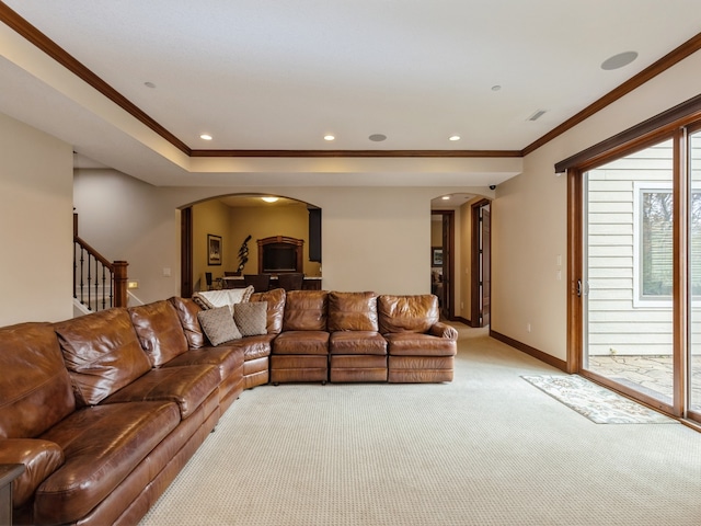 living room with baseboards, arched walkways, stairway, ornamental molding, and recessed lighting