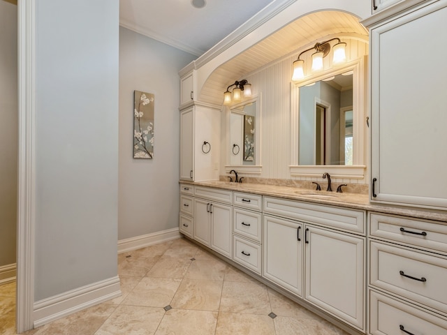 full bathroom featuring double vanity, crown molding, baseboards, and a sink