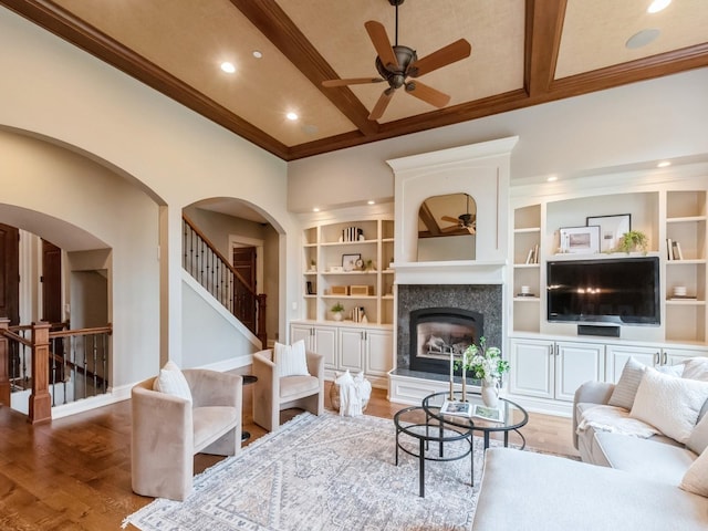 3123 162nd St, Urbandale, IA 50323 - living room featuring a ceiling fan, a glass covered fireplace, ornamental molding, recessed lighting, and stairway