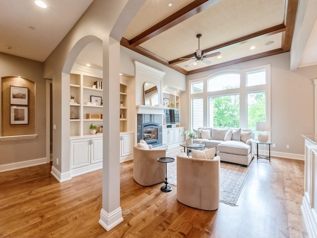3123 162nd St, Urbandale, IA 50323 - living room featuring ceiling fan, a glass covered fireplace, ornamental molding, light wood-type flooring, and baseboards