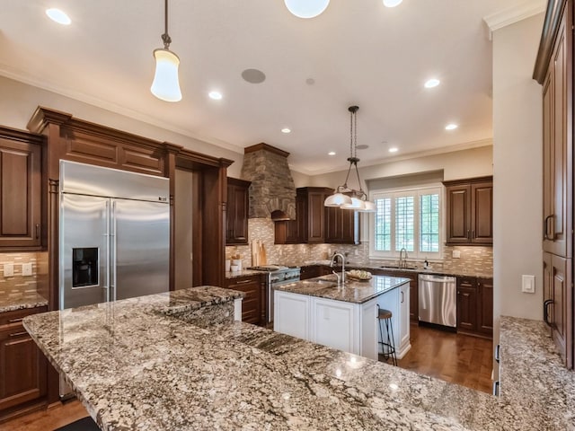 3123 162nd St, Urbandale, IA 50323 - kitchen featuring high end appliances, a sink, an island with sink, tasteful backsplash, and light stone countertops