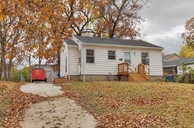 bungalow-style house featuring an outbuilding