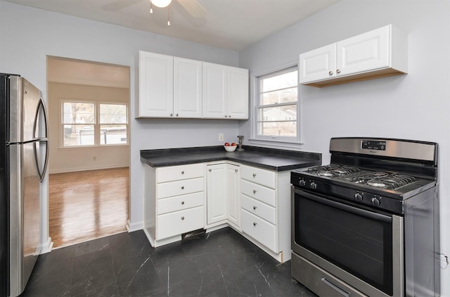 kitchen featuring white cabinets, ceiling fan, plenty of natural light, and appliances with stainless steel finishes