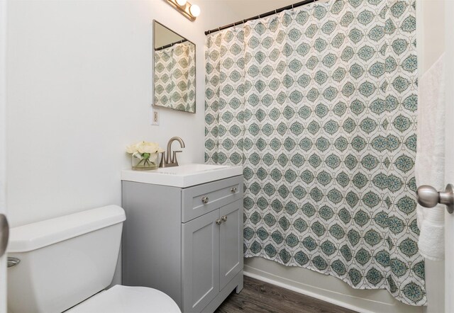 full bathroom featuring vanity, toilet, shower / bath combo with shower curtain, and wood-type flooring