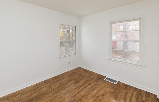 empty room with wood-type flooring