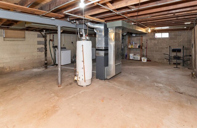 basement featuring heating unit, washer / clothes dryer, and gas water heater