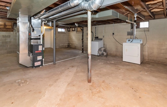 basement featuring separate washer and dryer and heating unit