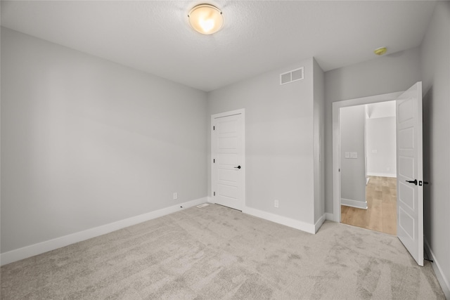 unfurnished bedroom featuring light colored carpet