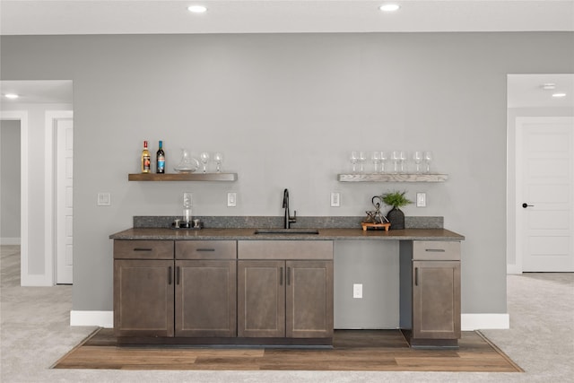 bar with carpet floors and sink