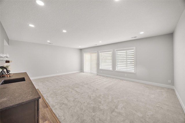 living room with light colored carpet and sink