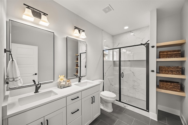 bathroom featuring tile patterned floors, vanity, toilet, and an enclosed shower