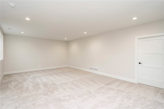 unfurnished room with light carpet