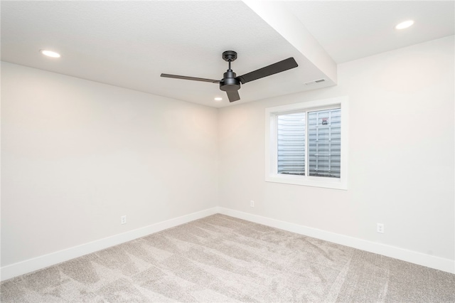 spare room featuring carpet and ceiling fan