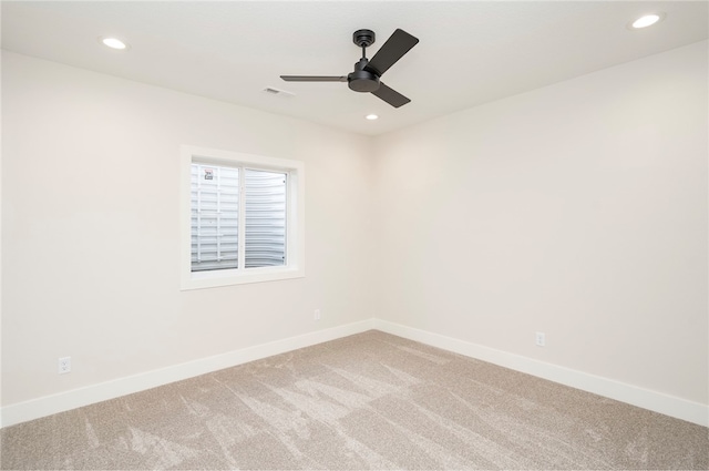 spare room featuring ceiling fan and carpet