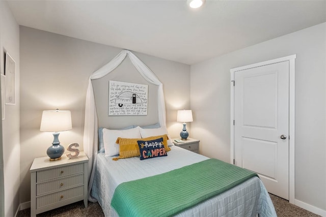 bedroom featuring dark colored carpet