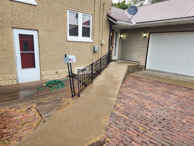 view of exterior entry with a garage