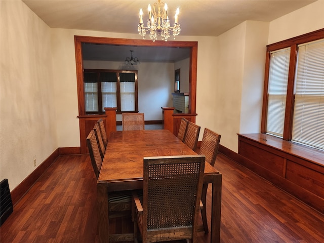 dining space with a chandelier and dark hardwood / wood-style flooring