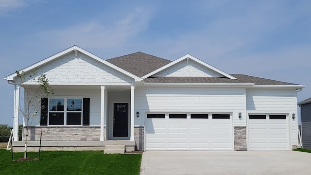 craftsman house with a garage and covered porch