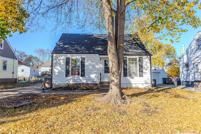 rear view of house featuring a lawn