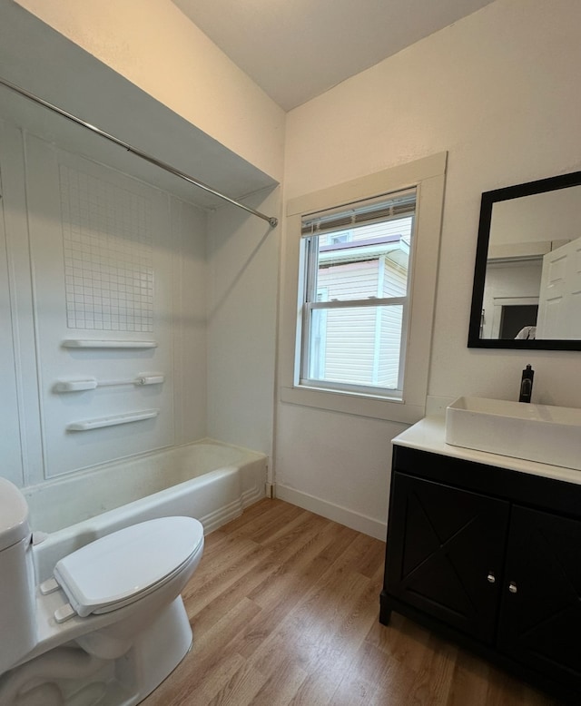 full bathroom with toilet, bathtub / shower combination, vanity, and hardwood / wood-style flooring