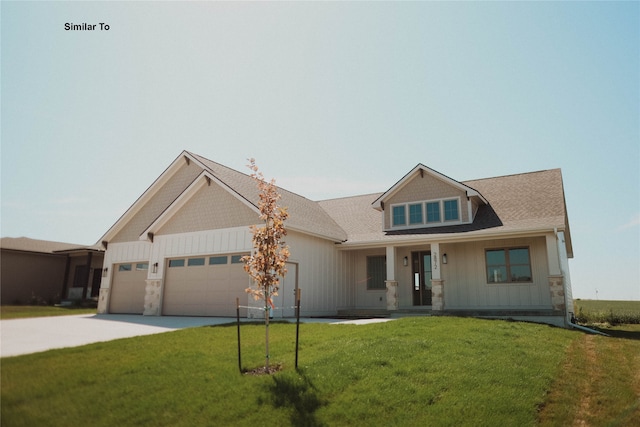 craftsman inspired home featuring a garage and a front lawn