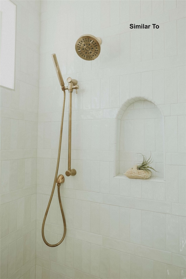 interior details featuring a tile shower