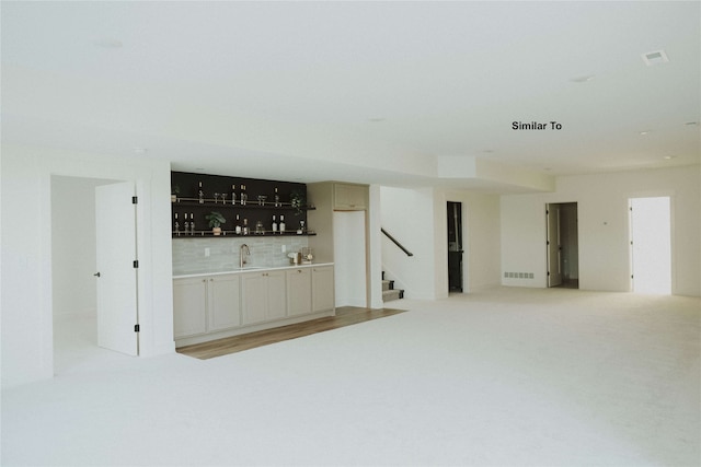 interior space featuring sink and backsplash