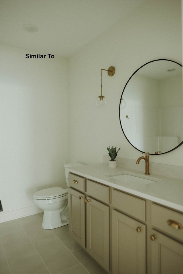 bathroom with vanity, tile patterned floors, and toilet