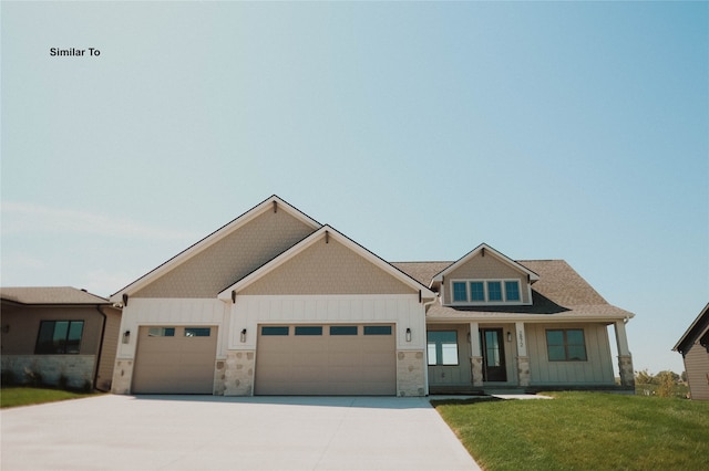 craftsman-style home featuring a front yard and a garage