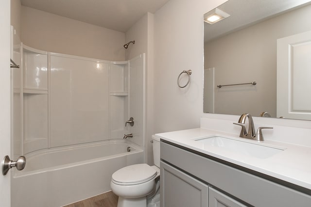 full bathroom featuring hardwood / wood-style floors, vanity, toilet, and tub / shower combination