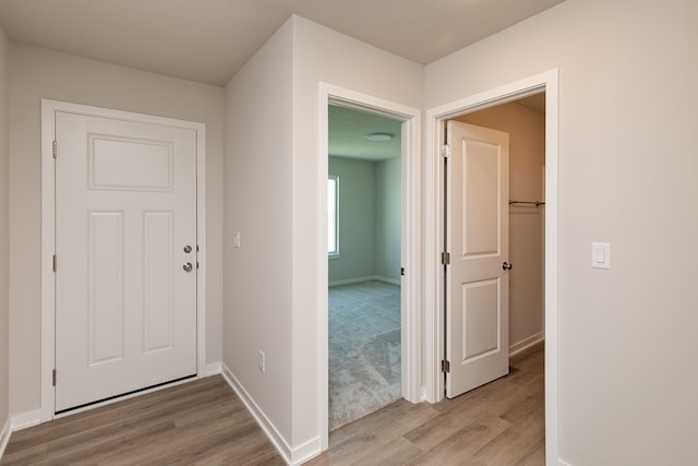 corridor featuring a textured ceiling and hardwood / wood-style flooring