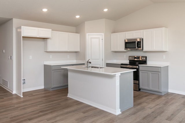 kitchen featuring sink, a center island with sink, gray cabinetry, and appliances with stainless steel finishes