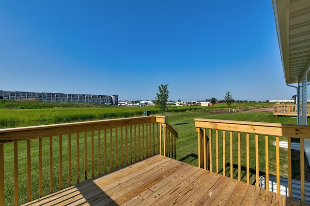 wooden terrace featuring a lawn