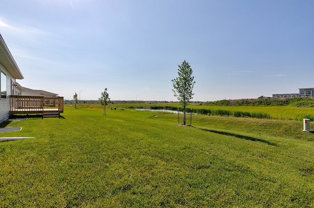 view of yard featuring a wooden deck and a rural view