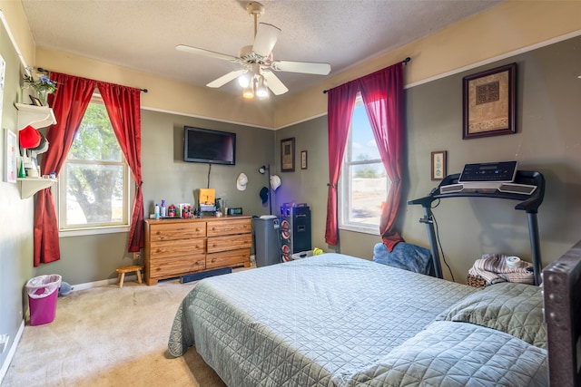 carpeted bedroom featuring a textured ceiling and ceiling fan