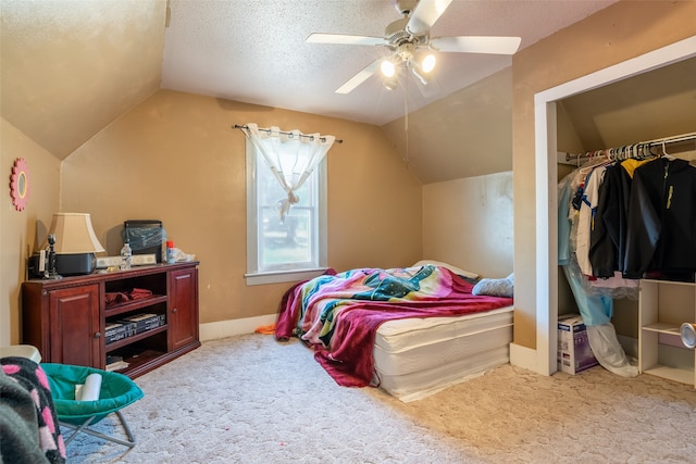 carpeted bedroom featuring ceiling fan, a textured ceiling, a closet, and lofted ceiling