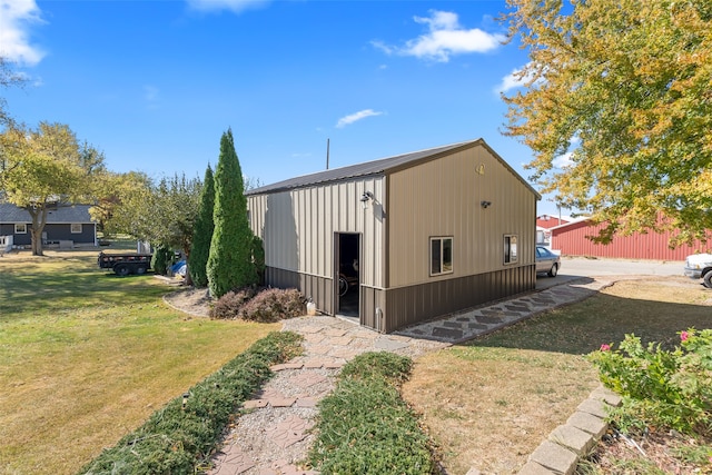 view of outbuilding featuring a yard