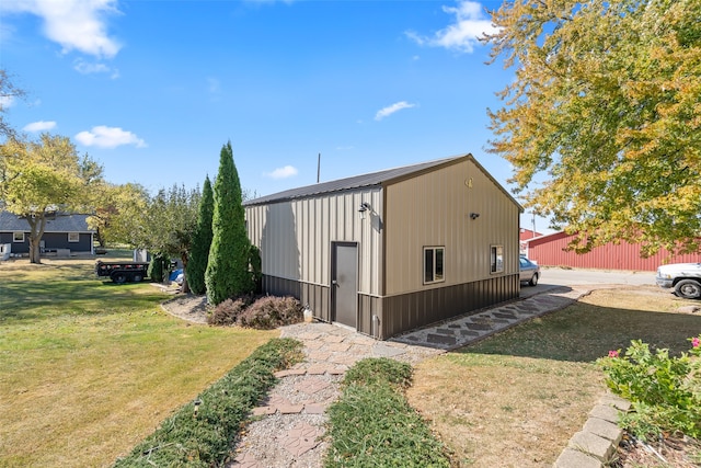 view of outbuilding featuring a yard