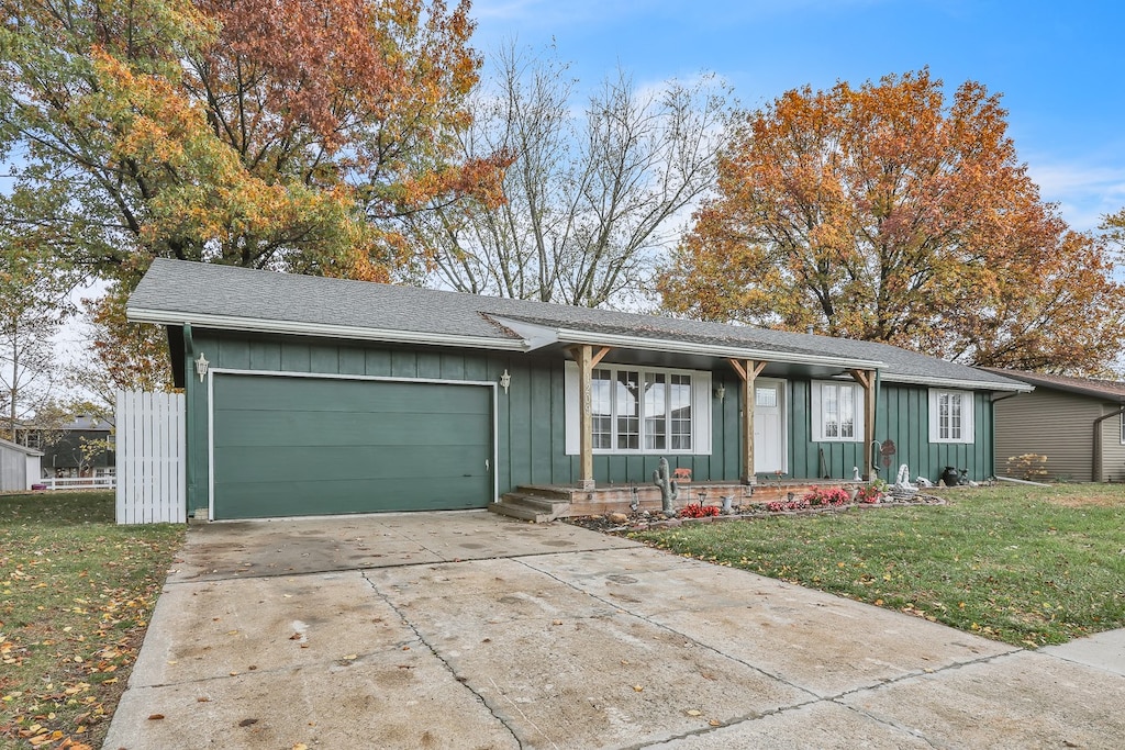 single story home with a garage and a front yard