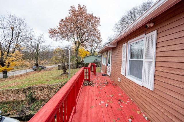 deck with a lawn and a fenced backyard