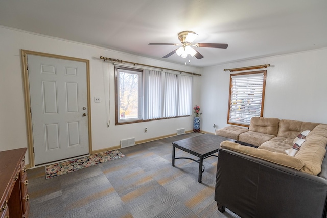 carpeted living room featuring ceiling fan, visible vents, and baseboards