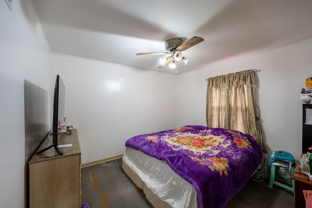 bedroom featuring dark wood-style floors, baseboards, ornamental molding, and a ceiling fan