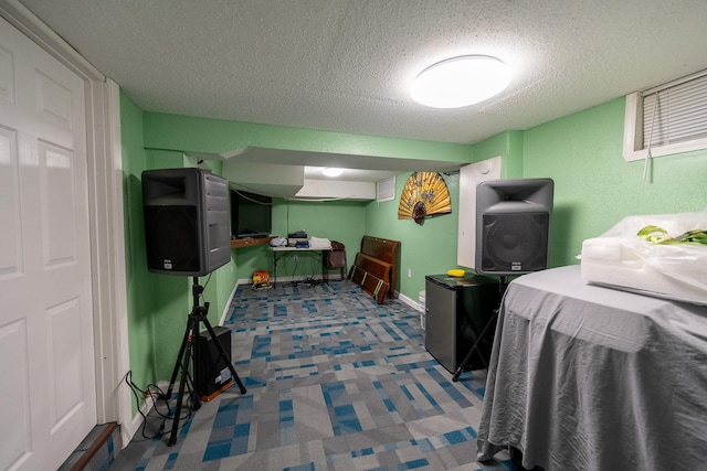 interior space featuring baseboards and a textured ceiling