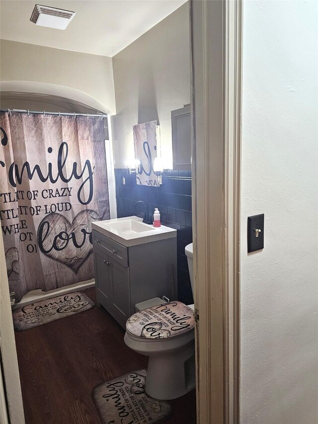 bathroom with tile patterned floors, visible vents, toilet, and vanity