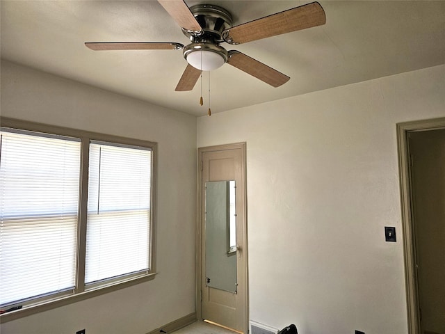 spare room with baseboards and ceiling fan