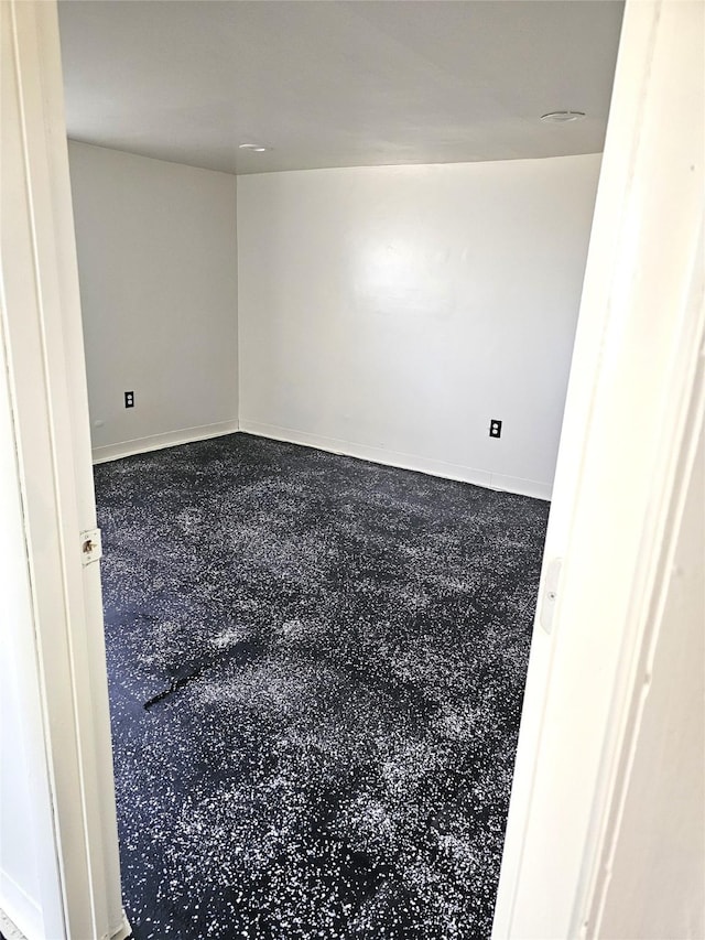 spare room with speckled floor