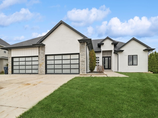 view of front of property featuring a garage and a front lawn