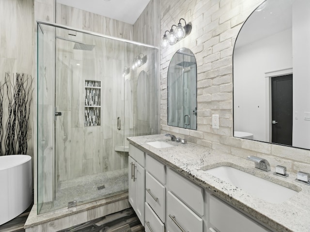 bathroom featuring hardwood / wood-style floors, vanity, and shower with separate bathtub