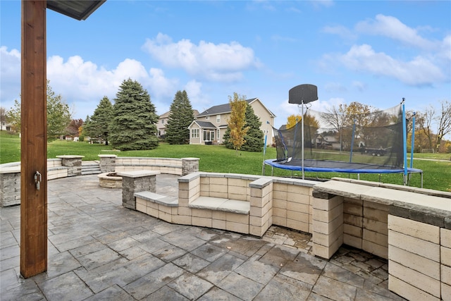 view of patio / terrace featuring an outdoor fire pit and a trampoline